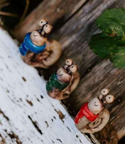 Ceramic snails in scarves side on